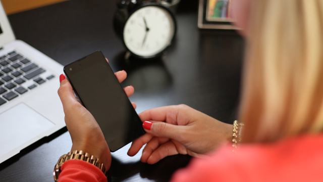 Woman with a phone at the table